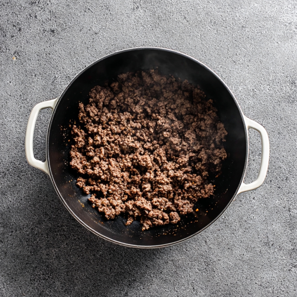 Ground beef browning in a large pot as the first step in making taco soup recipe at home