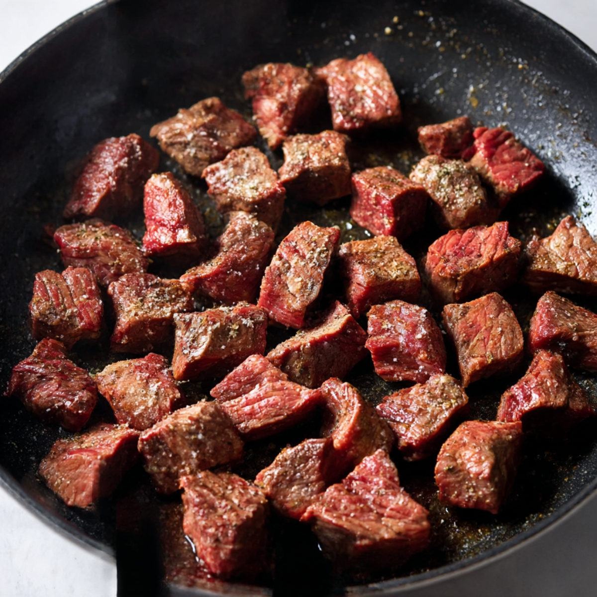 Tender beef cubes seasoned and seared to perfection, creating a deliciously flavorful dish. Ideal for quick meals or as a savory addition to any recipe.
