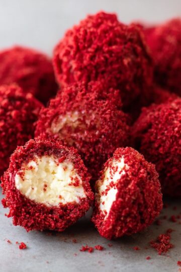 Delicious red velvet cheesecake balls rolled in red crumbs, with a creamy cheesecake center. A decadent dessert perfect for any occasion.