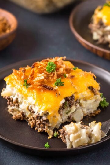 Hobo casserole with ground beef, creamy potatoes, and melted cheddar cheese on a plate