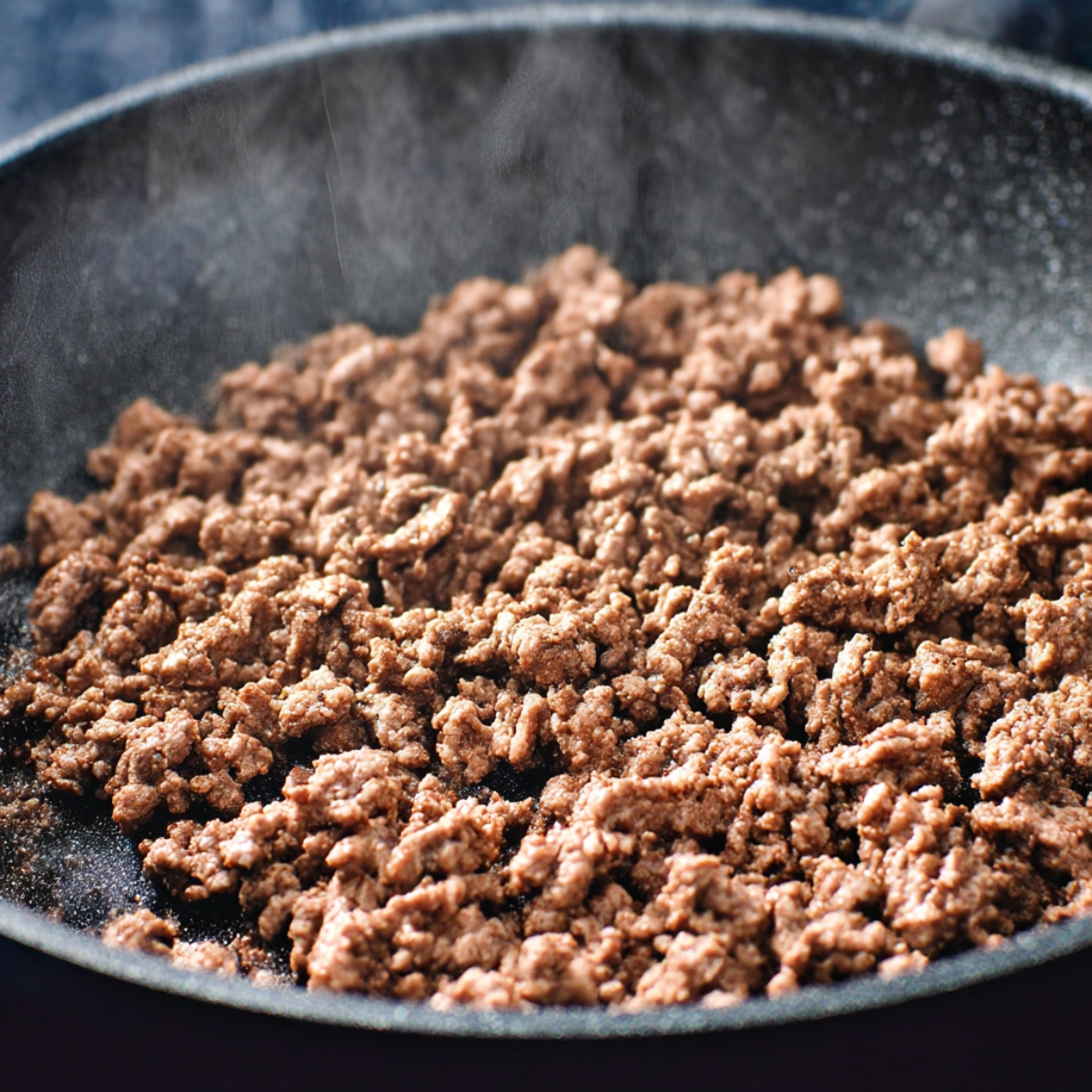 Close-up of perfectly cooked seasoned ground beef in a skillet, ready for assembling delicious keto crunchwraps, a low-carb Mexican-inspired meal.