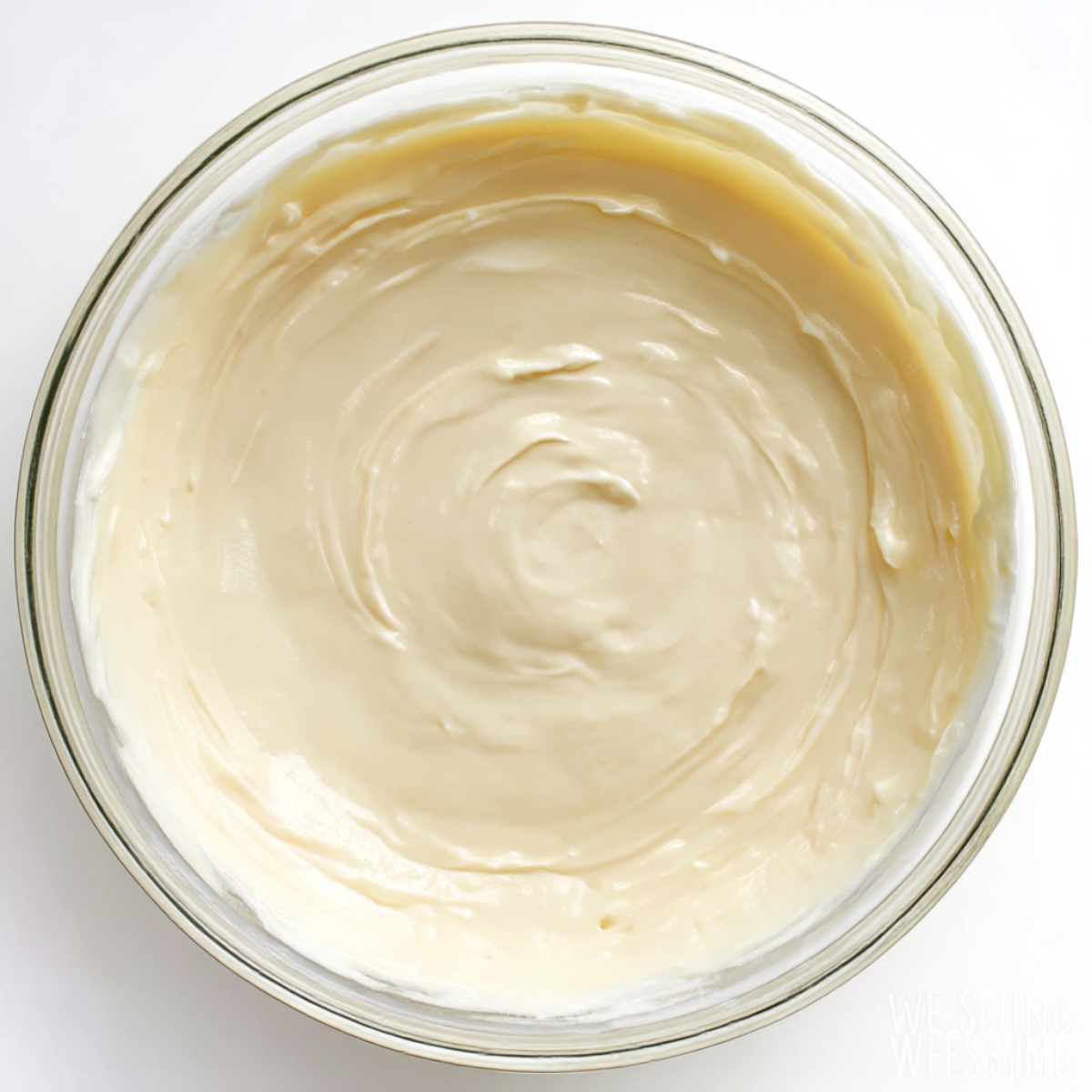 A glass bowl filled with smooth and creamy keto cheesecake filling, ready to be baked or chilled, perfect for a low-carb strawberry cheesecake.