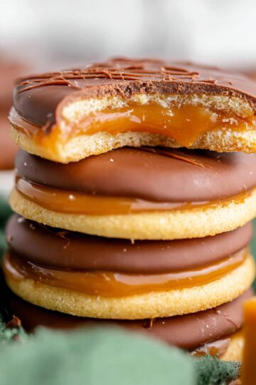 Close-up of stacked Twix Cookies with rich chocolate coating, gooey caramel layer, and buttery shortbread base, perfect for homemade dessert recipes.